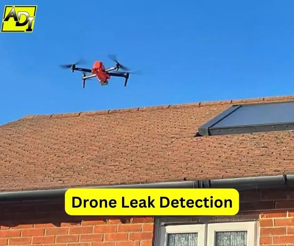 Red drone flying above residential roof