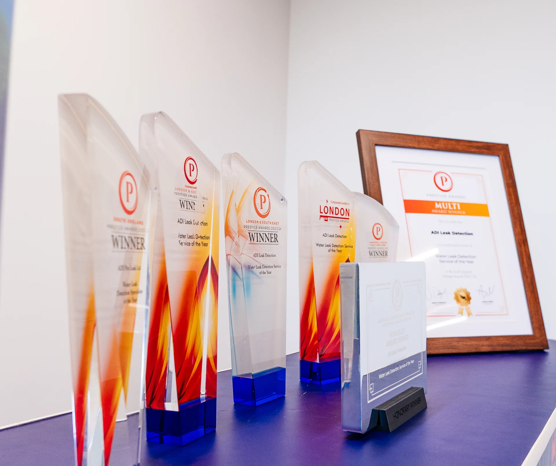 ADI’s Prestige Awards trophies and Multi Award Winner certificate on a purple shelf