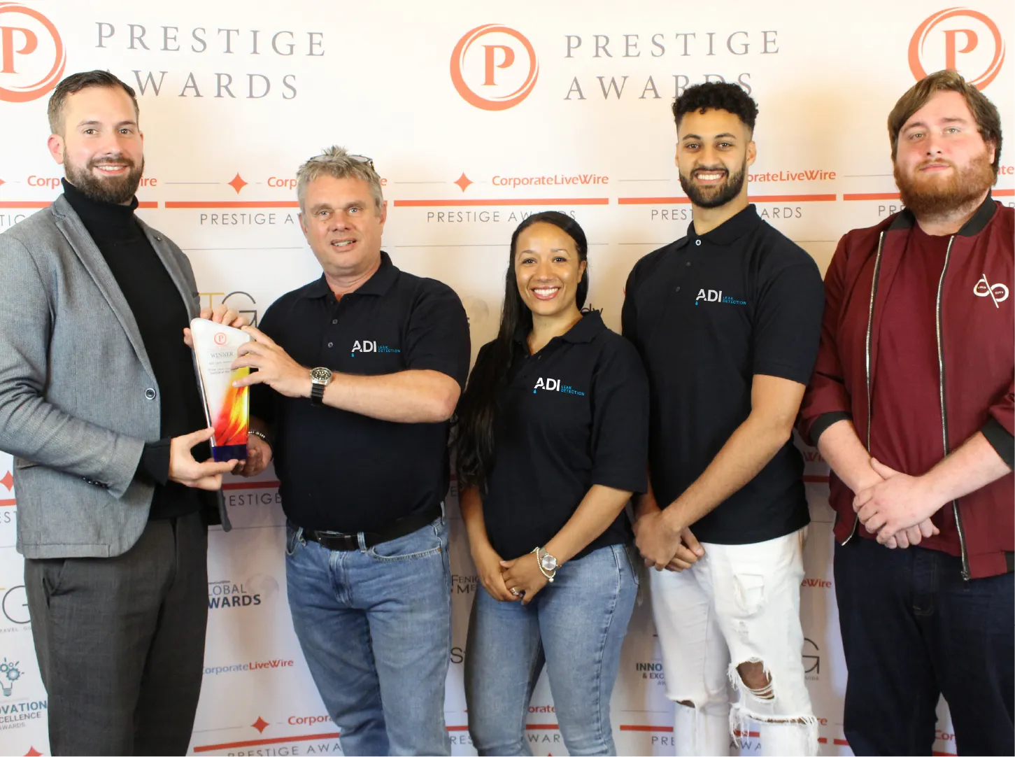ADI Leak Detection team receiving a winner trophy at a Corporate LiveWire Prestige Awards presentation