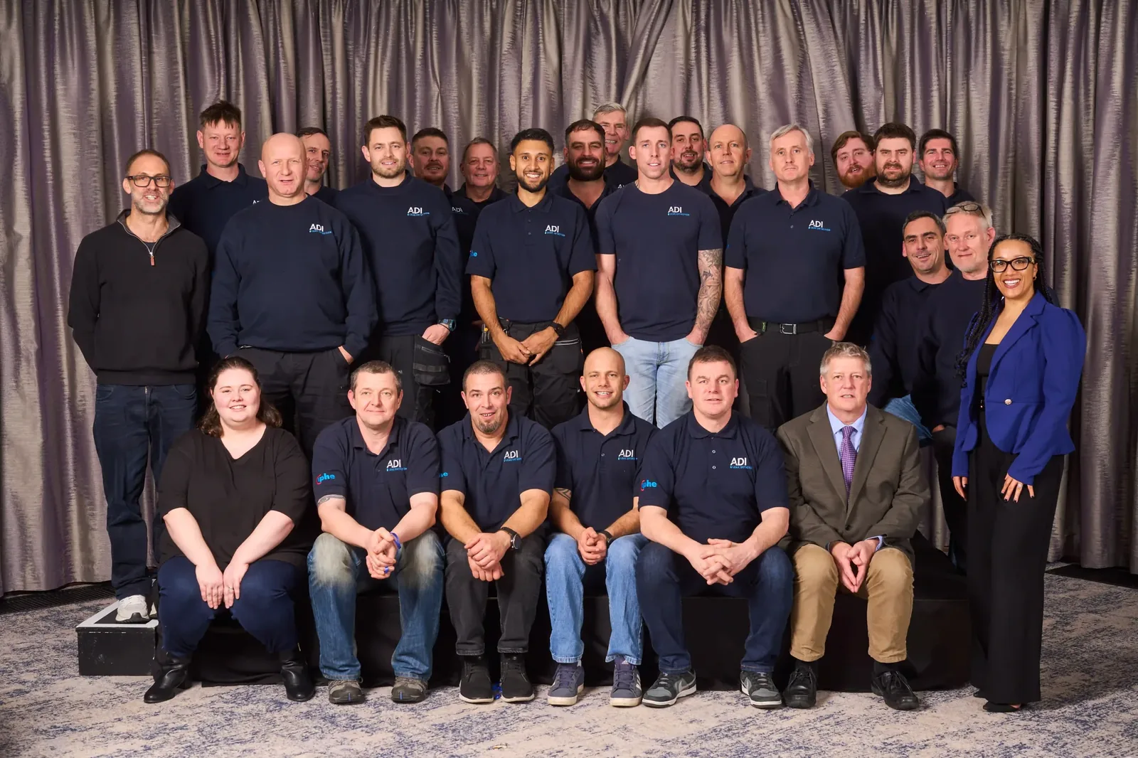 The ADI Leak Detection team photographed together: leak investigation engineers in ADI polo shirts alongside the office and leadership team.
