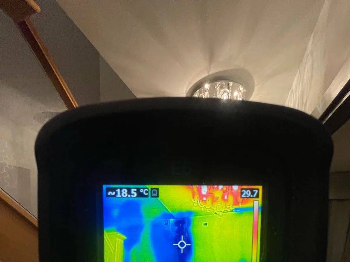 Thermal imaging camera screen showing heat signature around ceiling light fitting during a hot water leak detection survey at a property in Uxbridge