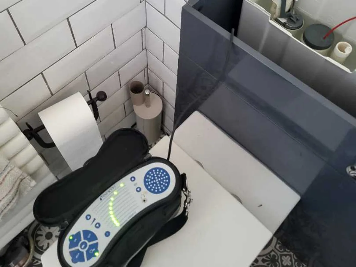 Tracer gas detector placed on toilet cistern during an internal mains leak detection survey at a property in ST3
