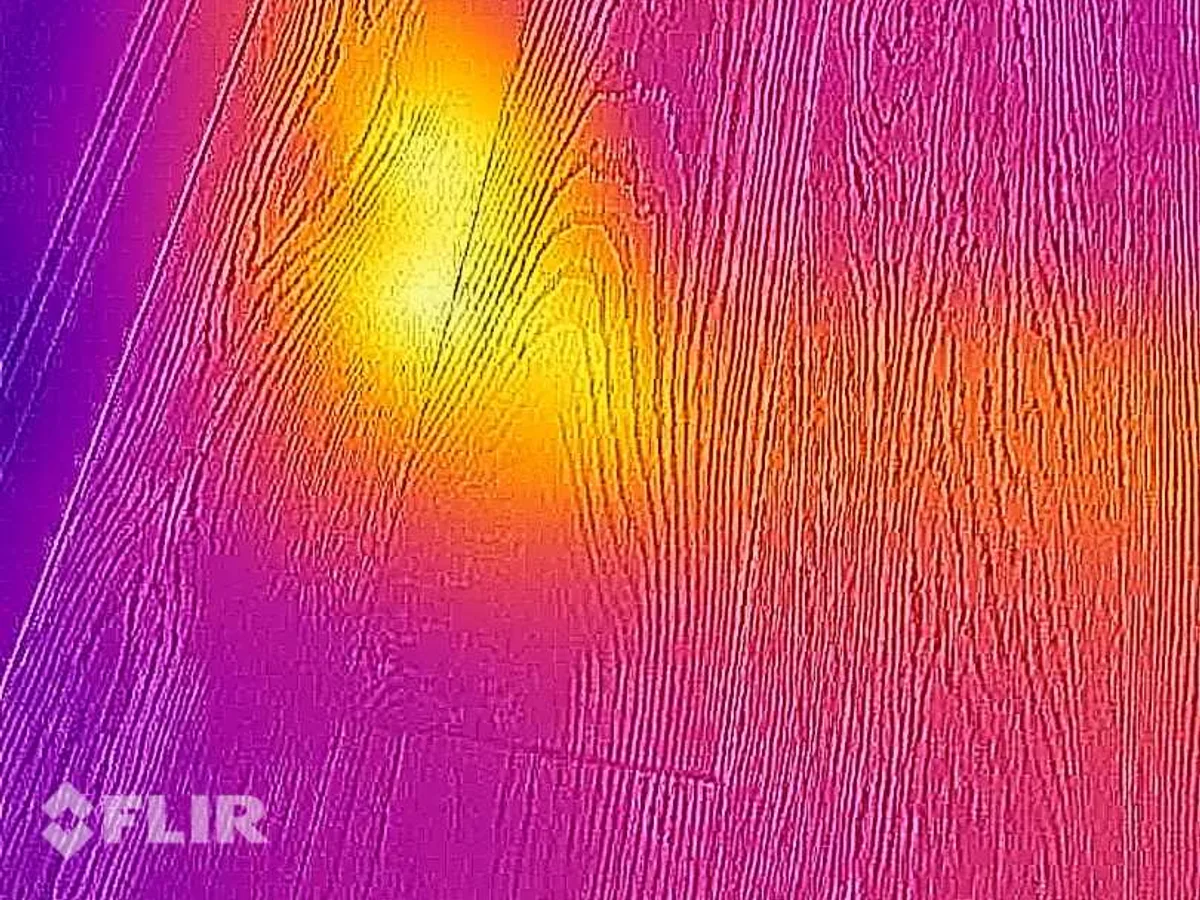 FLIR thermal image showing a hot spot on a wall surface during a central heating leak detection survey at a property in BA3