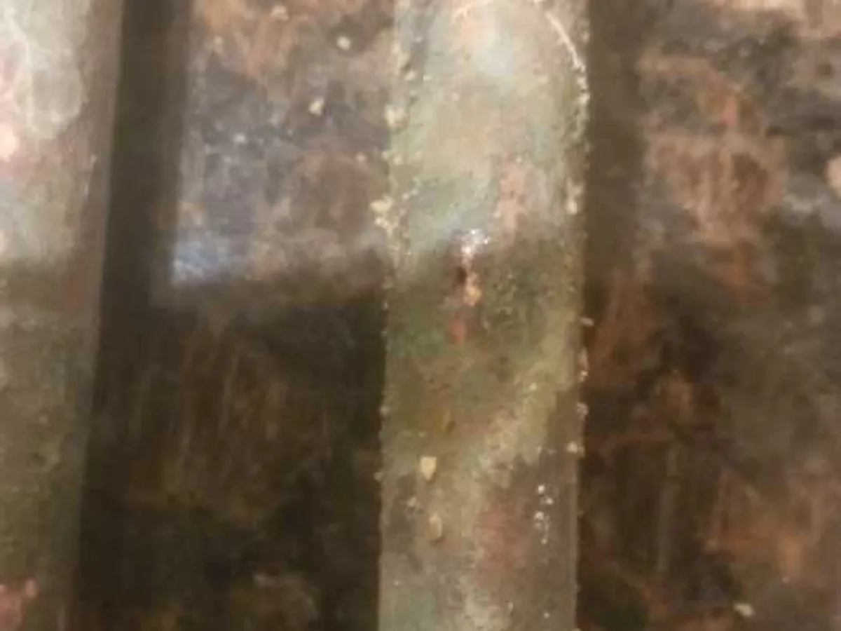 leak located at severely corroded and pitted copper pipe in concrete floor trench