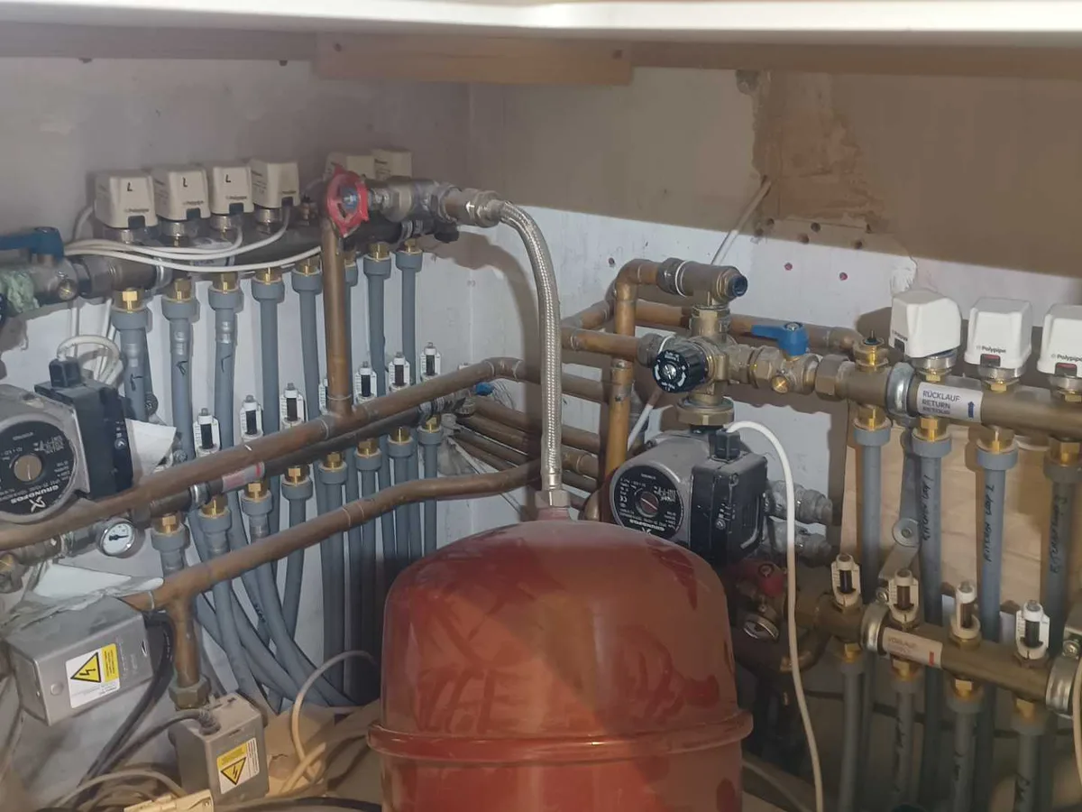 two underfloor heating manifolds in utility room cupboard before leak detection works