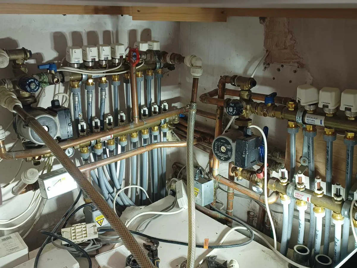 underfloor heating manifold pipework in utility cupboard before works started