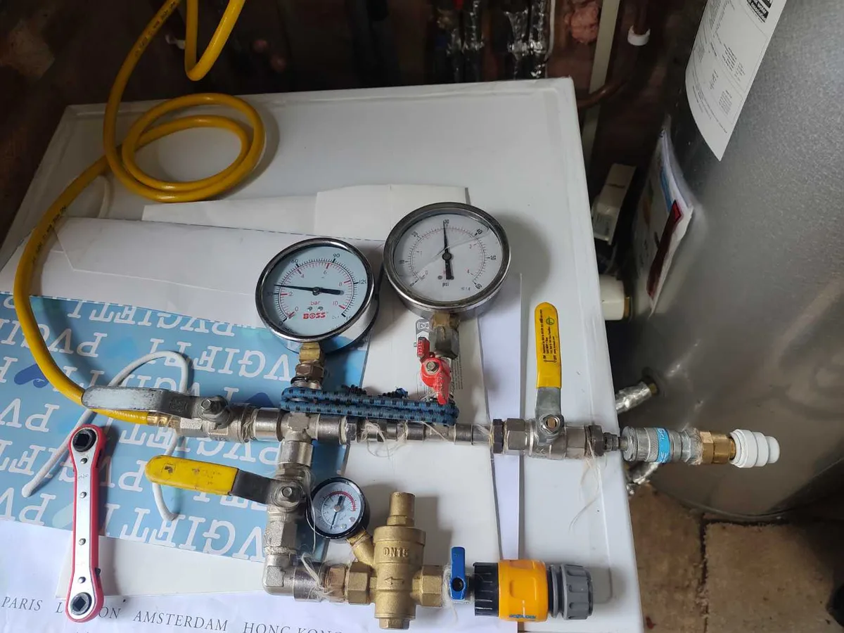 pressure test rig with dual gauges connected to heating system during leak detection