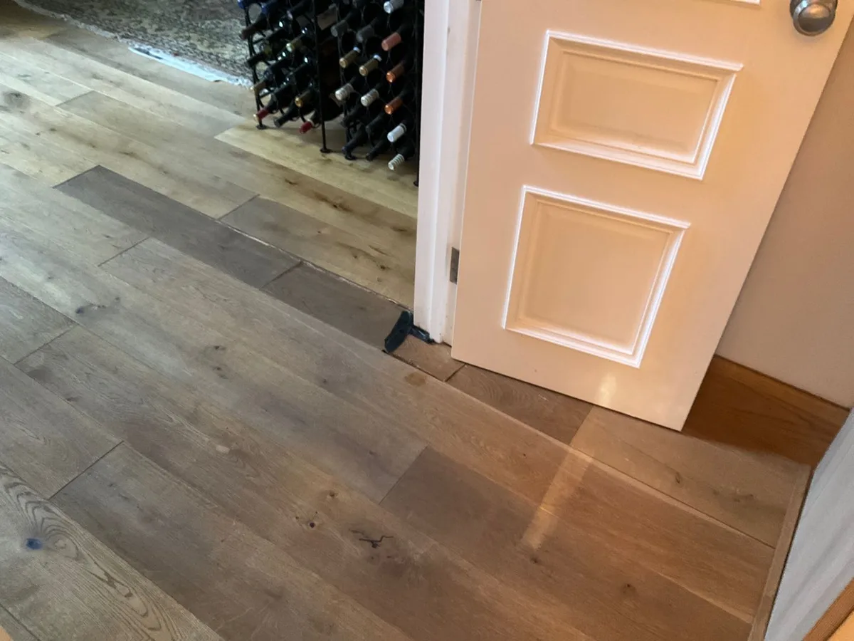 engineered wood flooring at hallway door threshold reinstated after repair