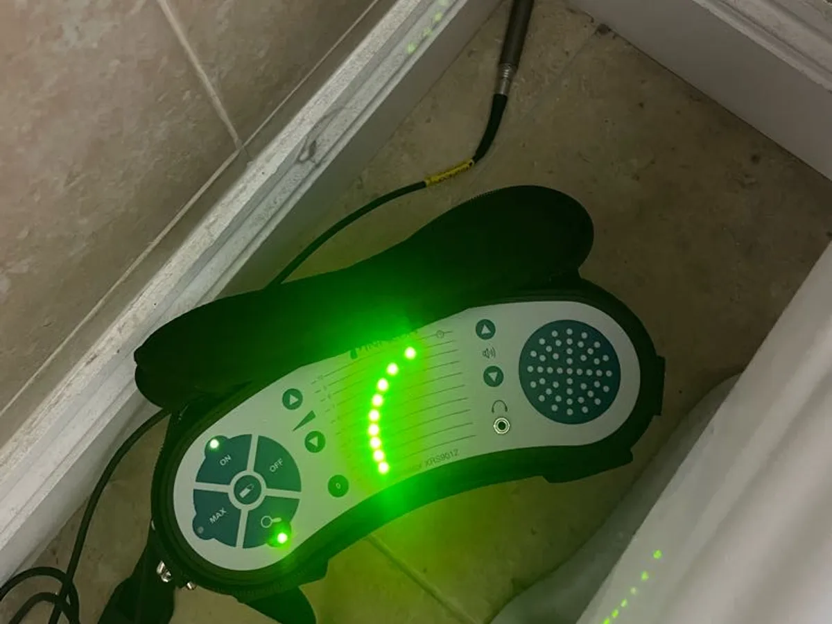 electronic tracer gas sensor active in bathroom corner during leak detection survey