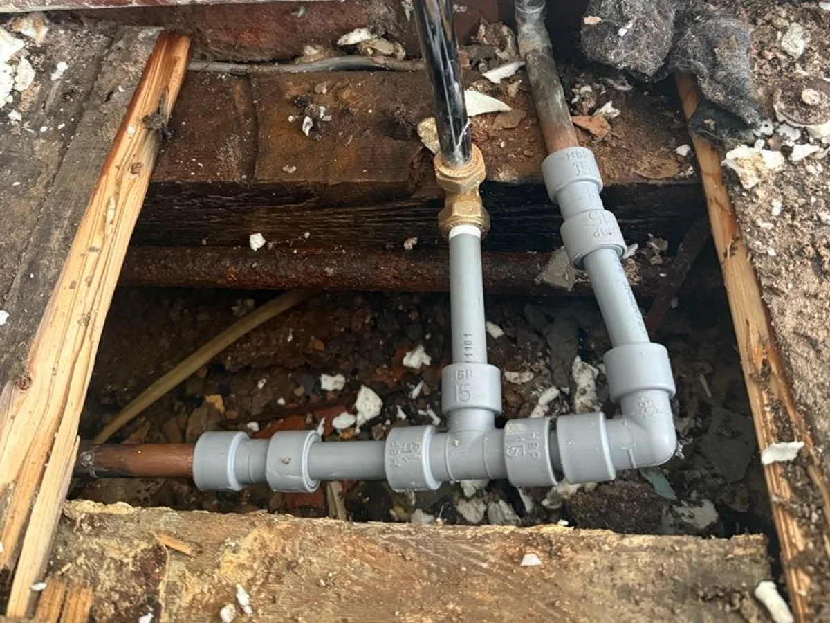 new plastic push-fit couplers and 15mm pipework installed as repair completed beneath kitchen floor