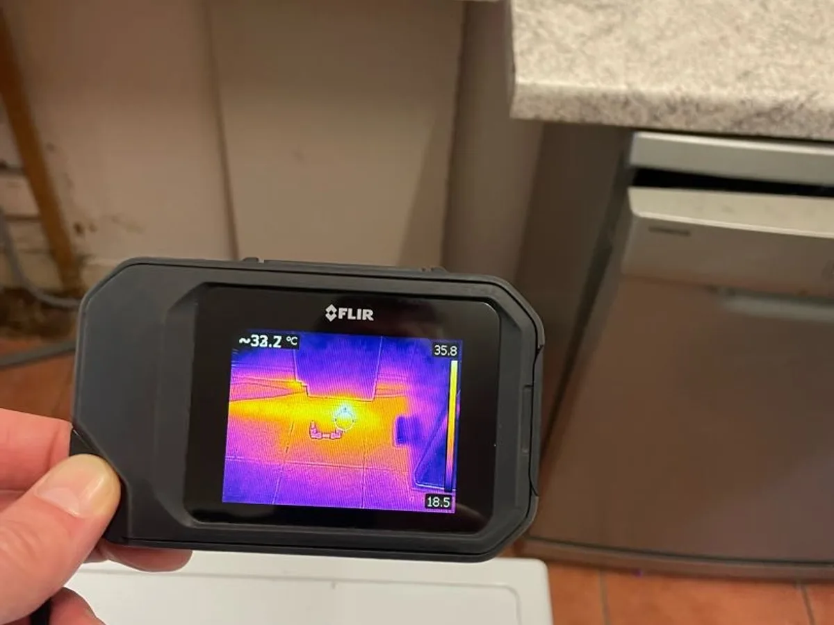 thermal imaging camera showing high temperature reading on kitchen floor during leak detection