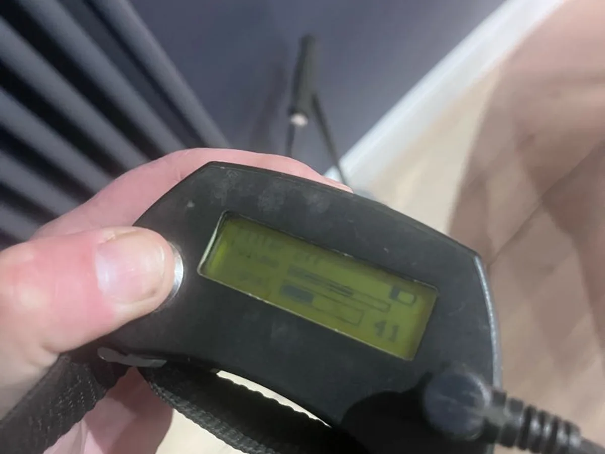 acoustic listening device display in use near living room radiator during leak detection