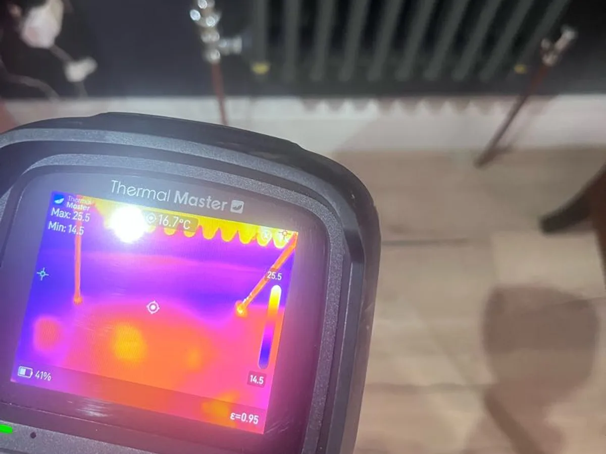 thermal imaging camera screen showing heat signature of buried heating pipes during leak detection