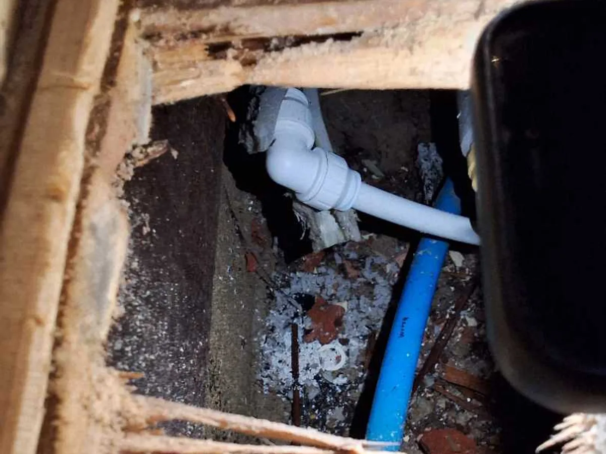 new 15mm push-fit elbow replacement fitted beneath lifted hallway floor after repair completed