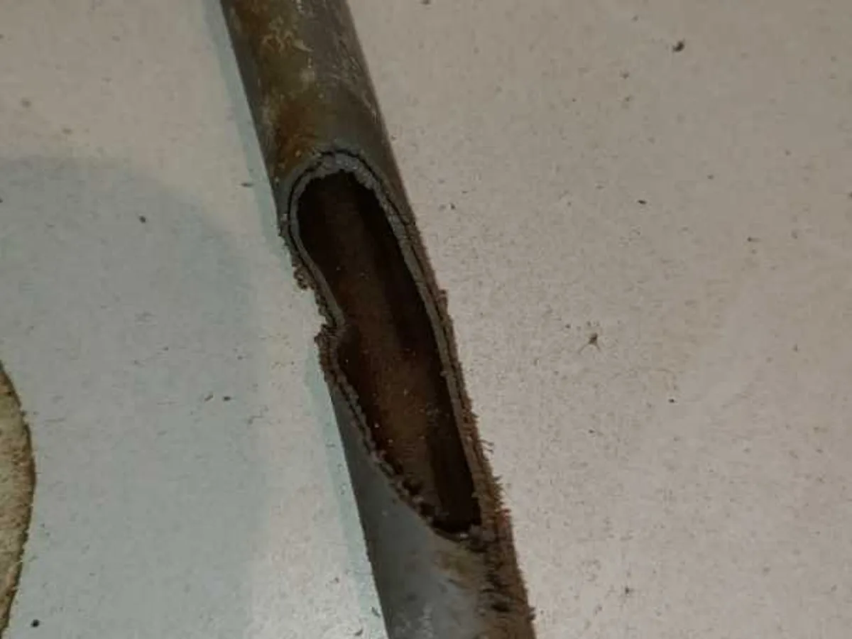 leak located at rat-gnawed 15mm grey plastic heating pipe with large hole chewed through wall