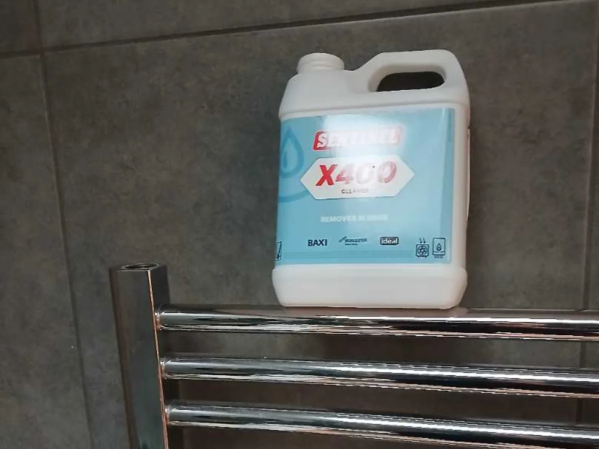 heating system cleaner placed on towel rail after works completed following successful repair