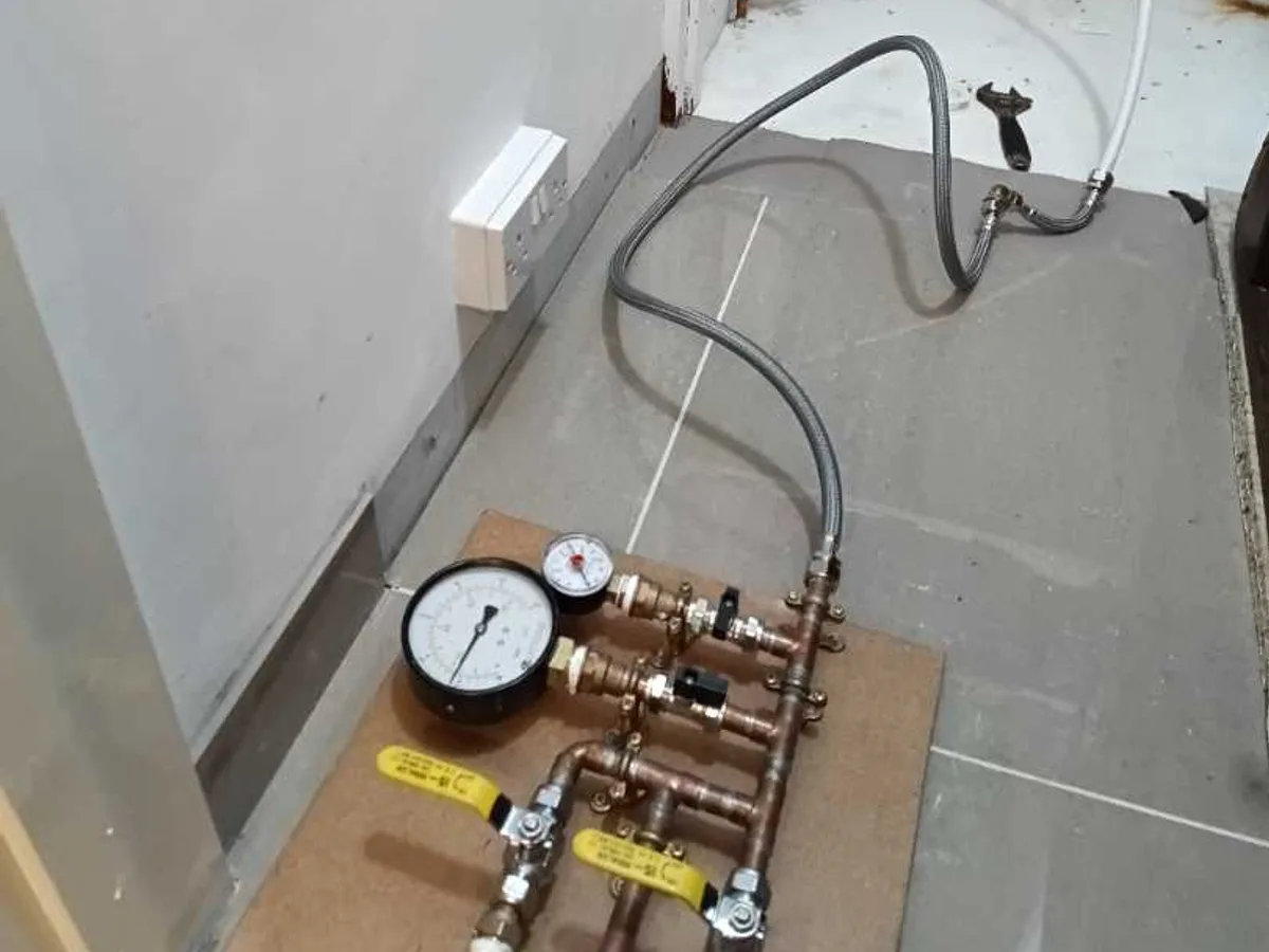 tracer gas test rig connected to copper heating manifold during leak detection survey