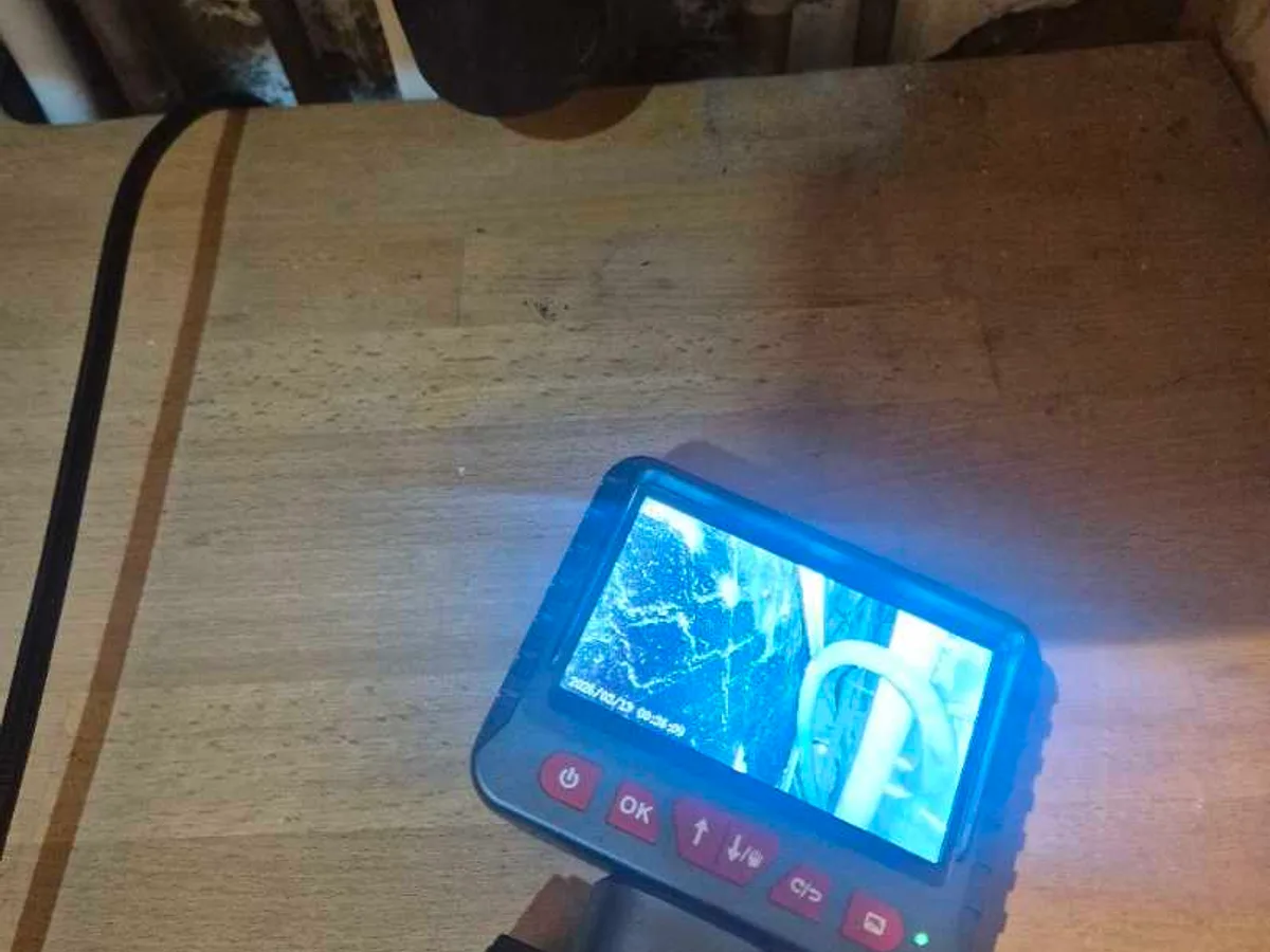 borescope camera screen showing damp wall cavity during leak detection survey