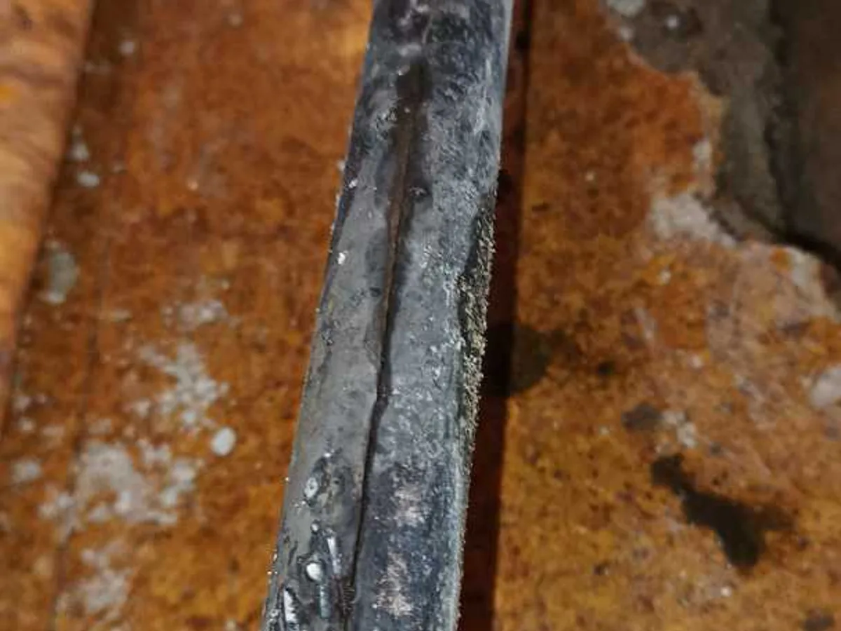 leak found at large longitudinal crack running along 28mm copper heating pipe surface