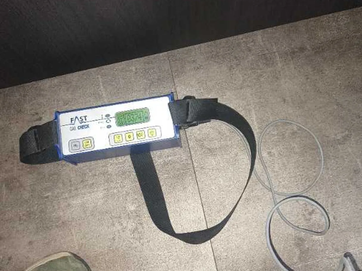 tracer gas detector unit placed on tiled kitchen floor during leak detection