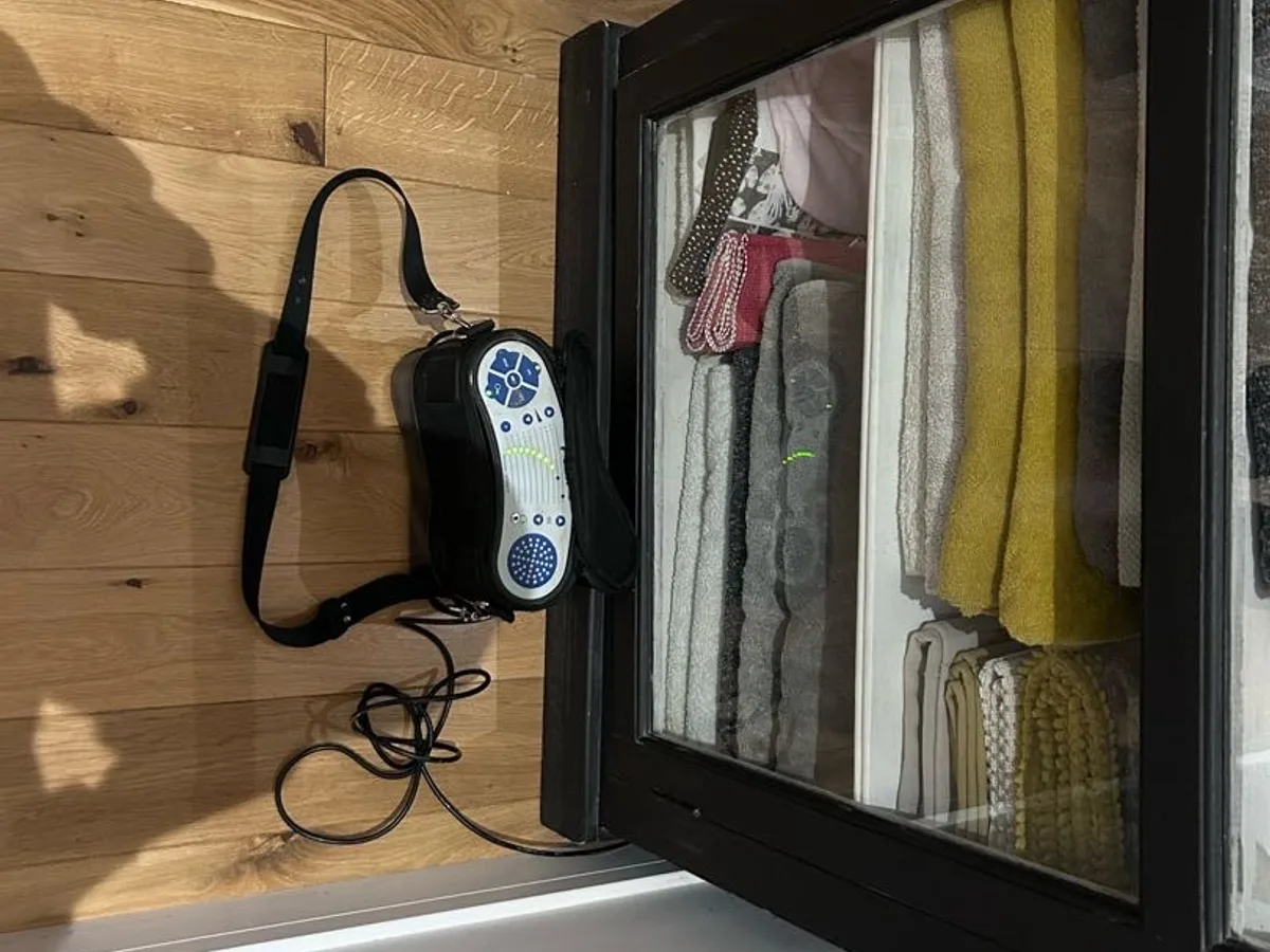tracer gas detector placed against wooden panel beside wardrobe unit during leak detection survey