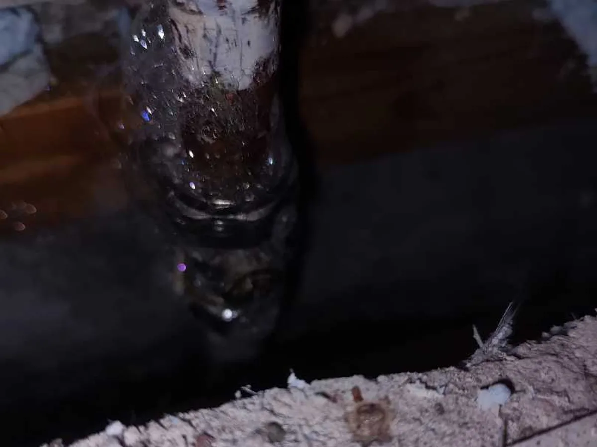 leak located at corroded 15mm service valve exposed within boxed pipework in bathroom