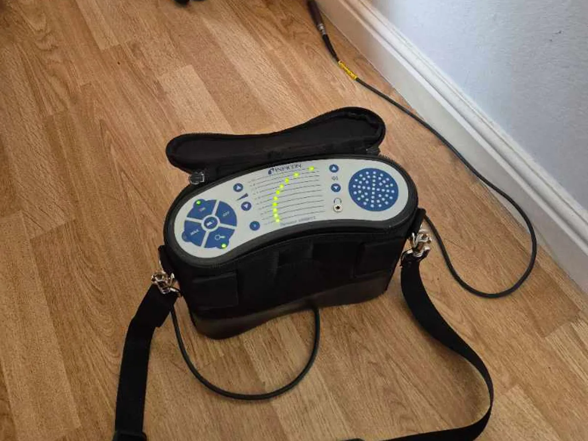 leak detection equipment placed on floor beside radiator pipework during leak detection