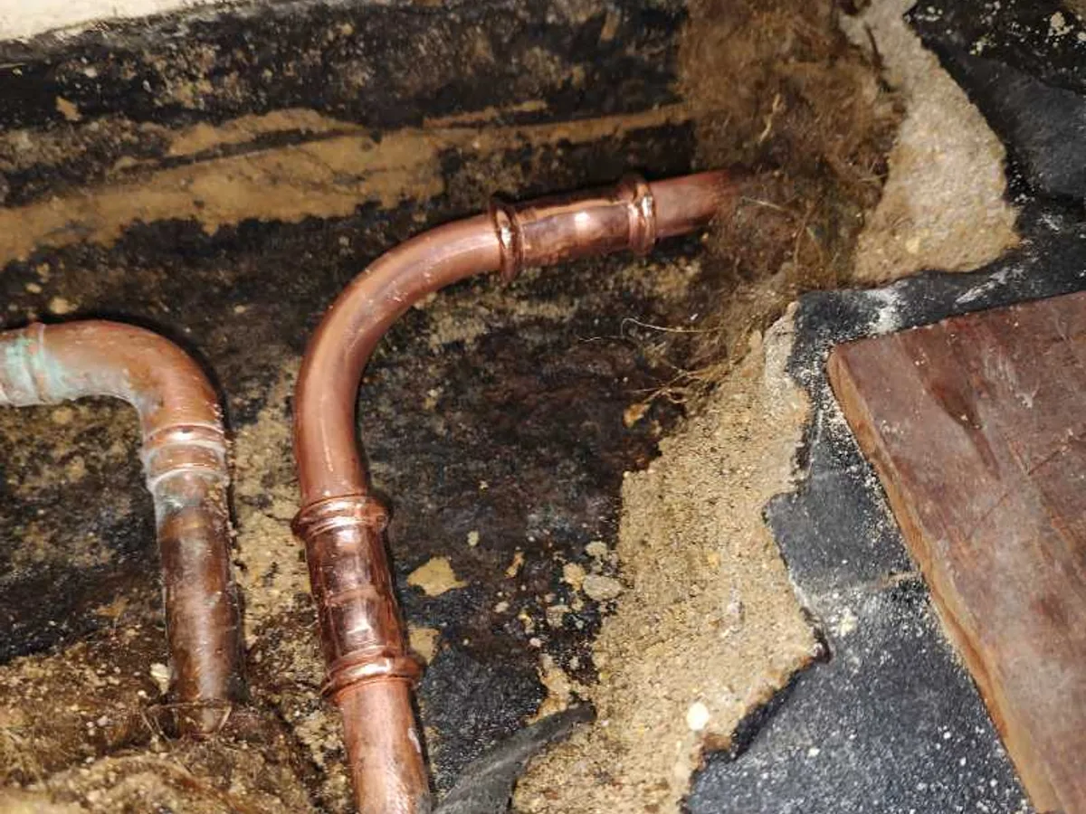 new 15mm copper pipe and bent fittings installed in subfloor void as repair completed