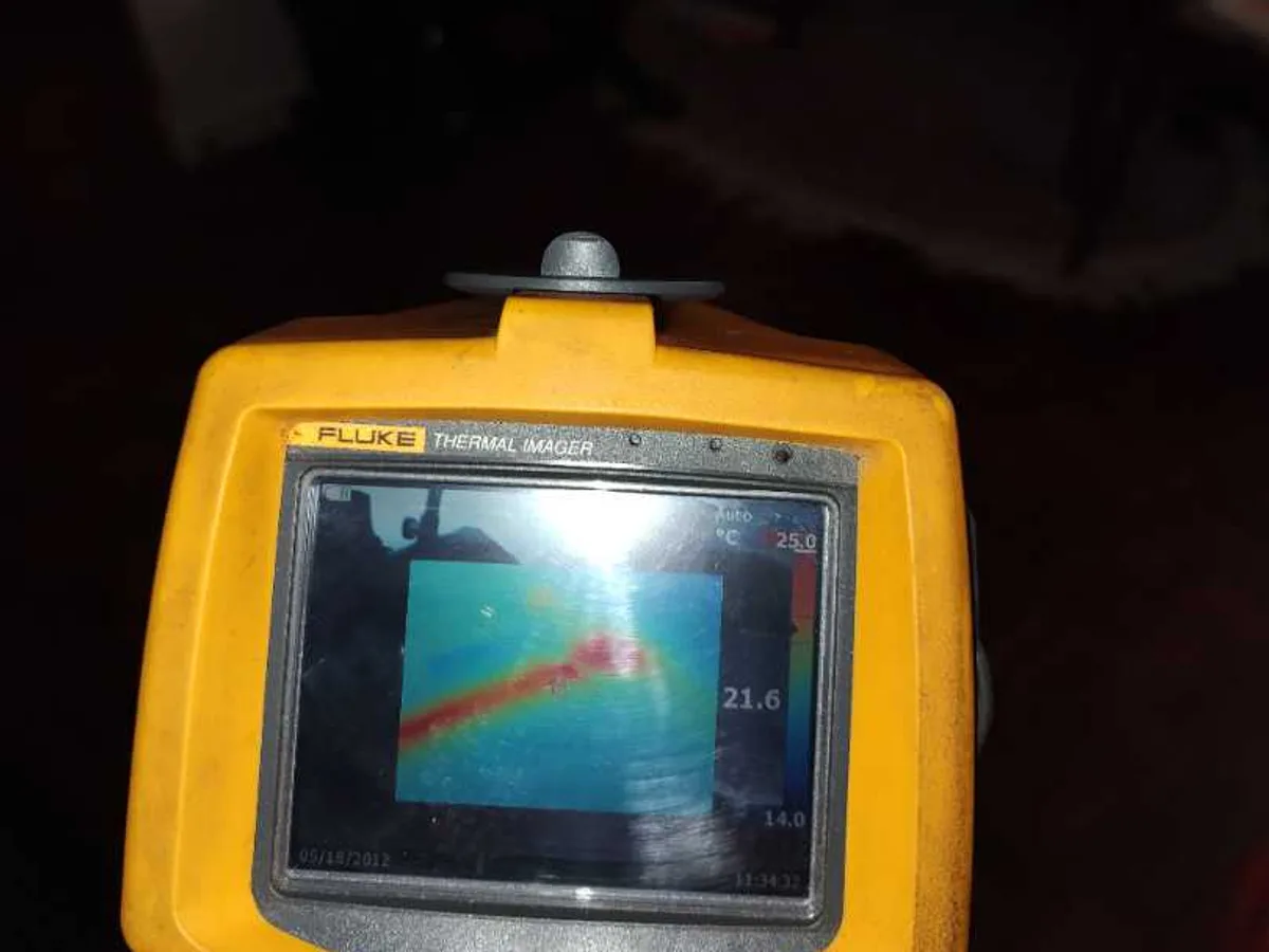 thermal imaging camera screen showing heat trace on floor during leak detection survey