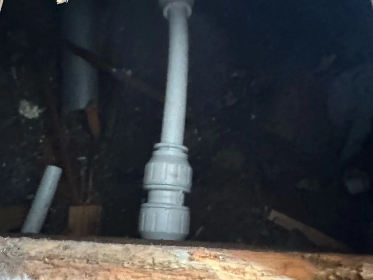 new push-fit isolation valve installed beneath floorboards as repair completed