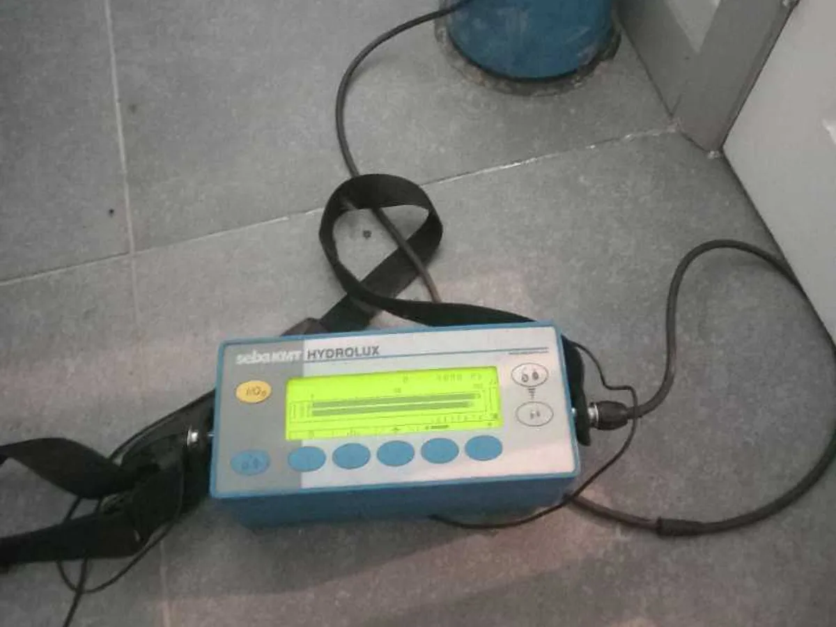 leak detection equipment and sensor on tiled kitchen floor during leak detection