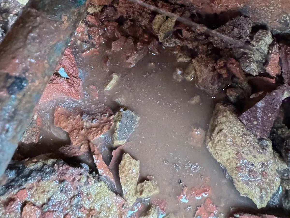leak located at base of excavated external wall cavity with pooled discoloured water