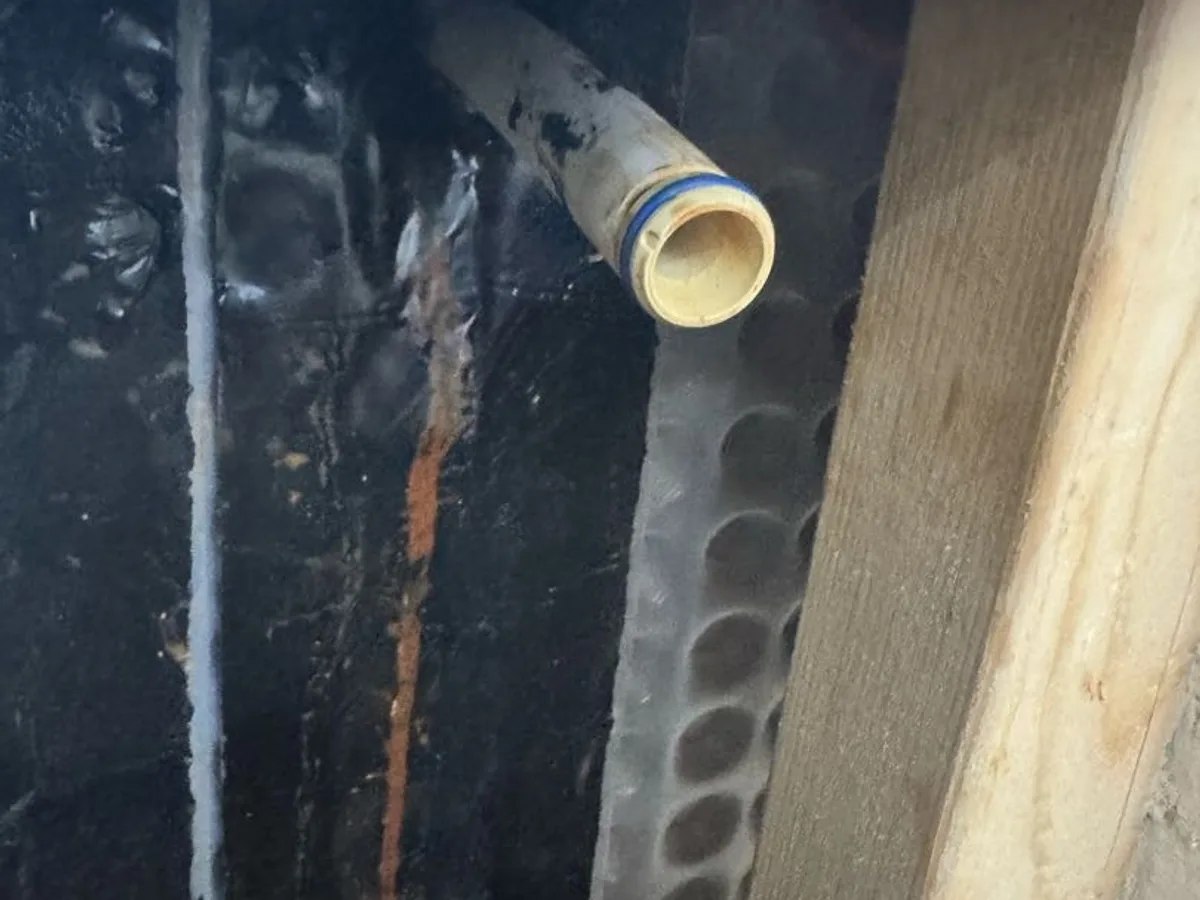 leak located at paint-coated pipe end preventing correct seal inside compression fitting in wall
