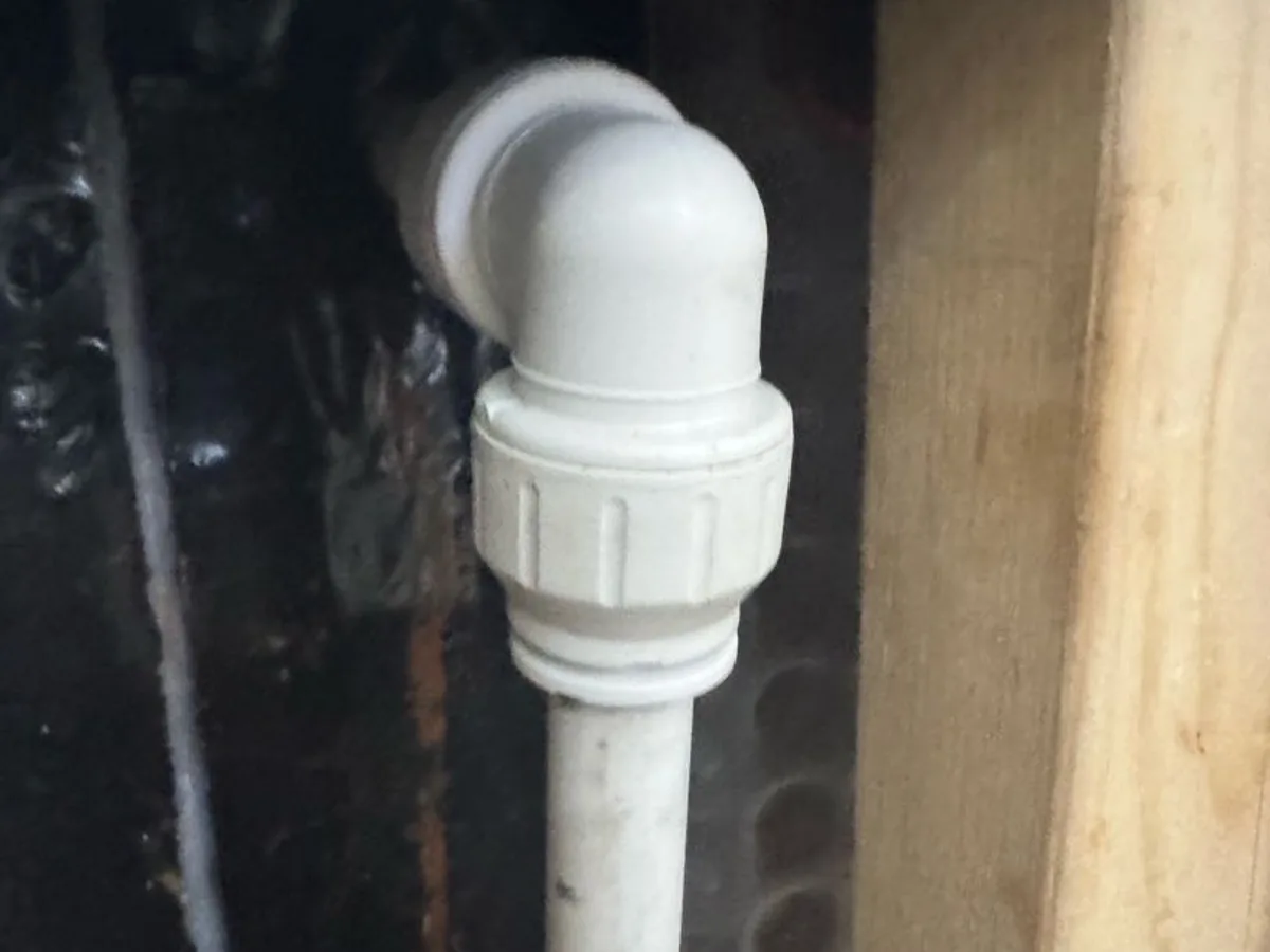 new compression elbow fitting and pipe installed as repair completed in lounge wall cavity
