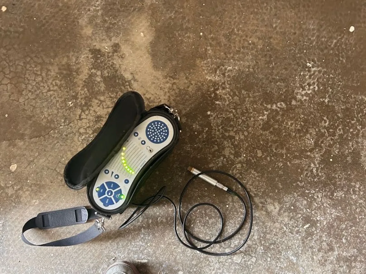 acoustic listening device on wet screed floor in hallway while testing for leak pinpoint