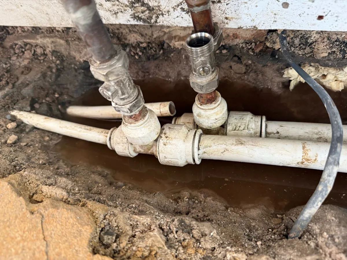 leak found at buried heating pipework tee fittings exposed after tiled floor lifted