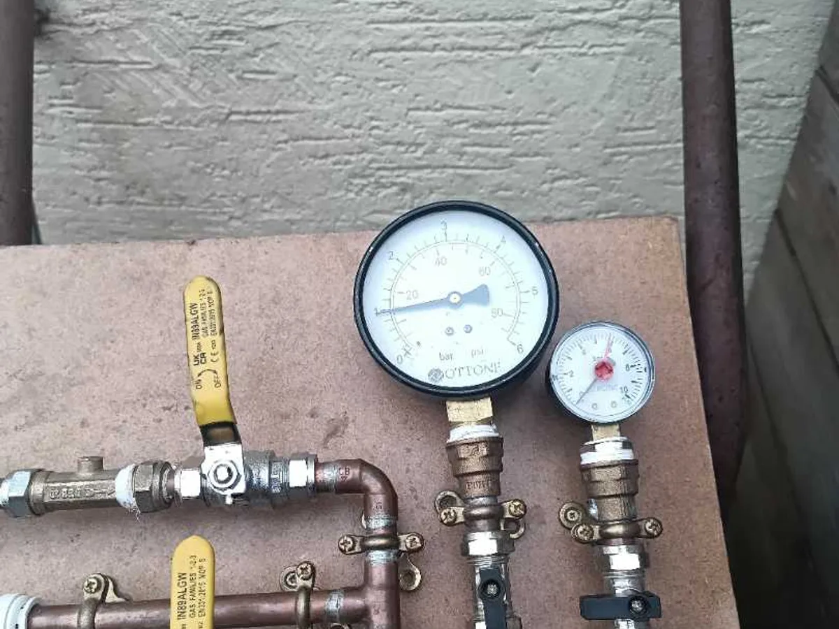 pressure test rig with dual gauges and isolation valves connected to pipework during leak detection