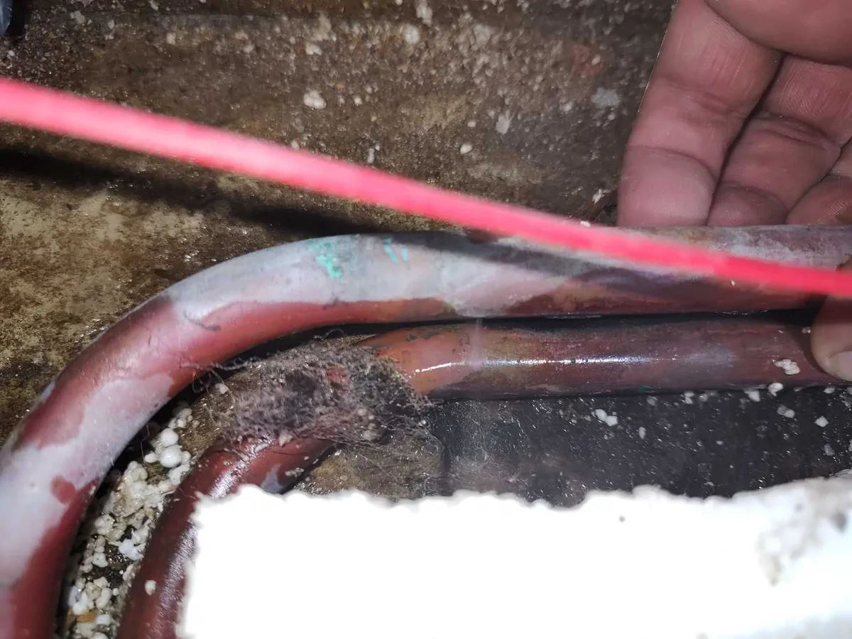 leak located at corroded 15mm copper hot water pipe exposed beneath en suite floor