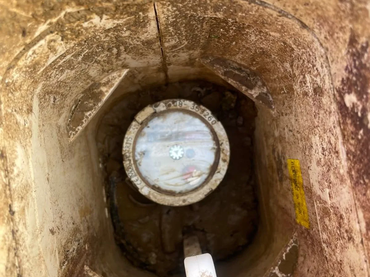 water meter in underground chamber showing movement during leak detection investigation