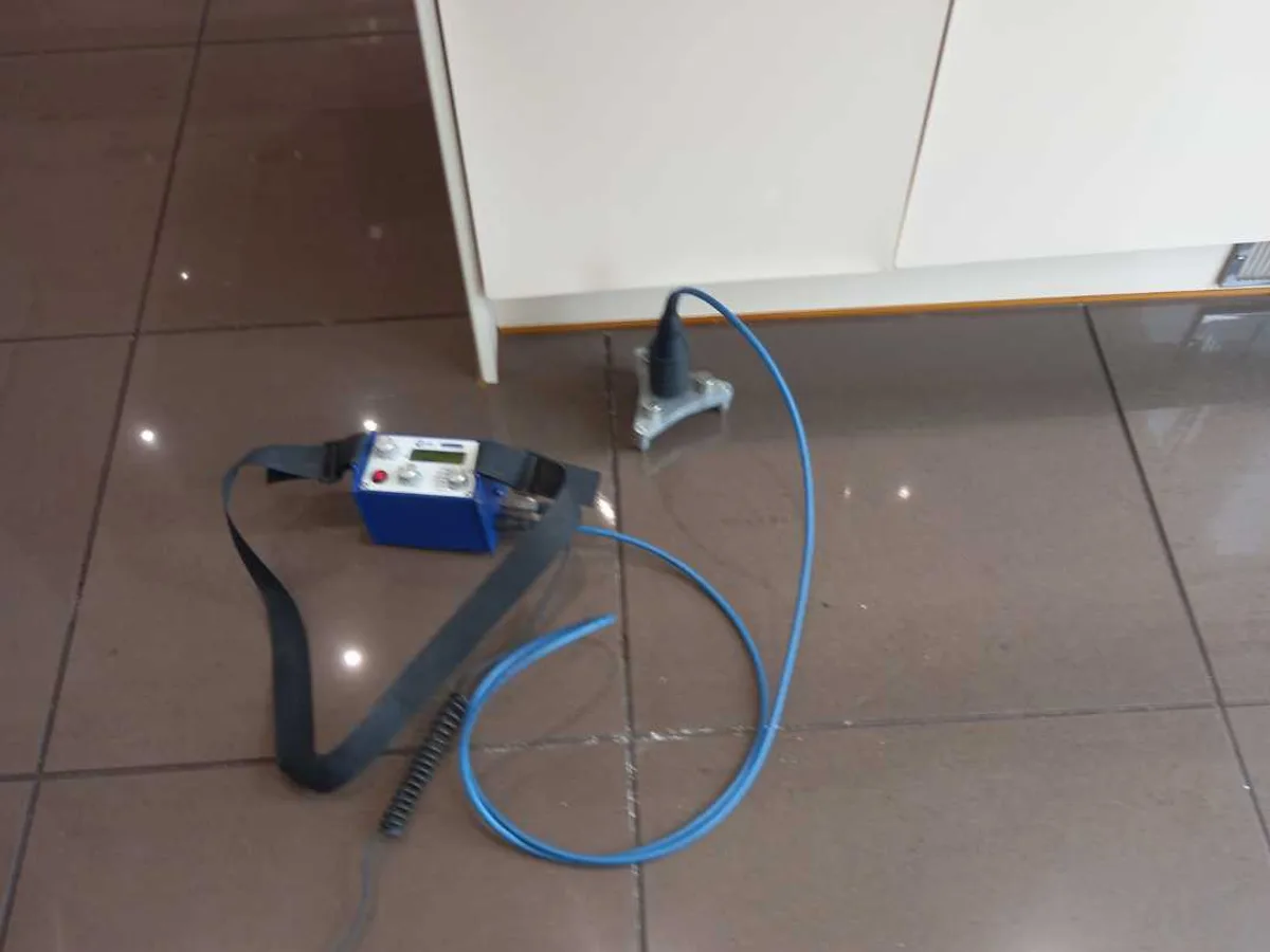 acoustic ground microphone and control unit on kitchen floor tiles during leak detection