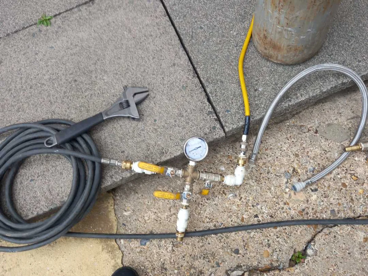 pressure test manifold with gauge and gas cylinder connected during leak detection