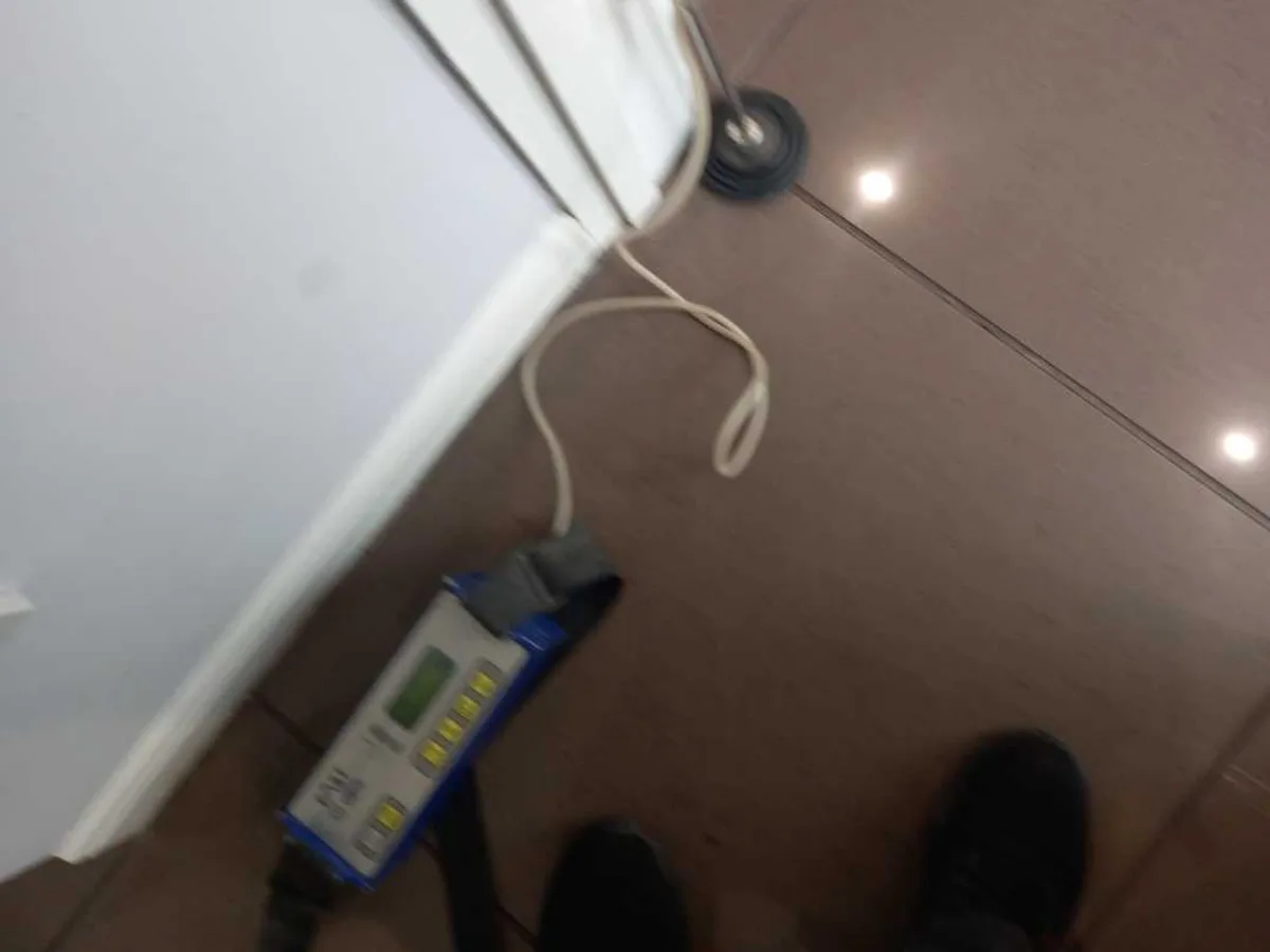 tracer gas detector unit on kitchen floor tiles in use during investigation