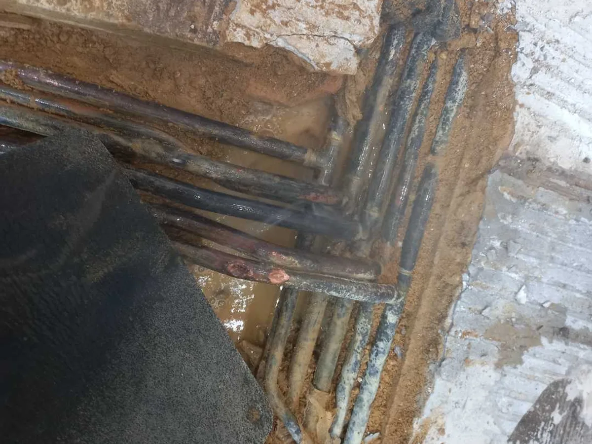 leak located at wet corroded copper pipework exposed in excavated kitchen floor