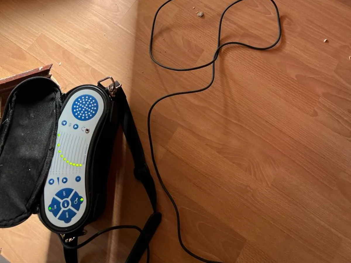 tracer gas detector probe fed beneath kitchen flooring during leak detection