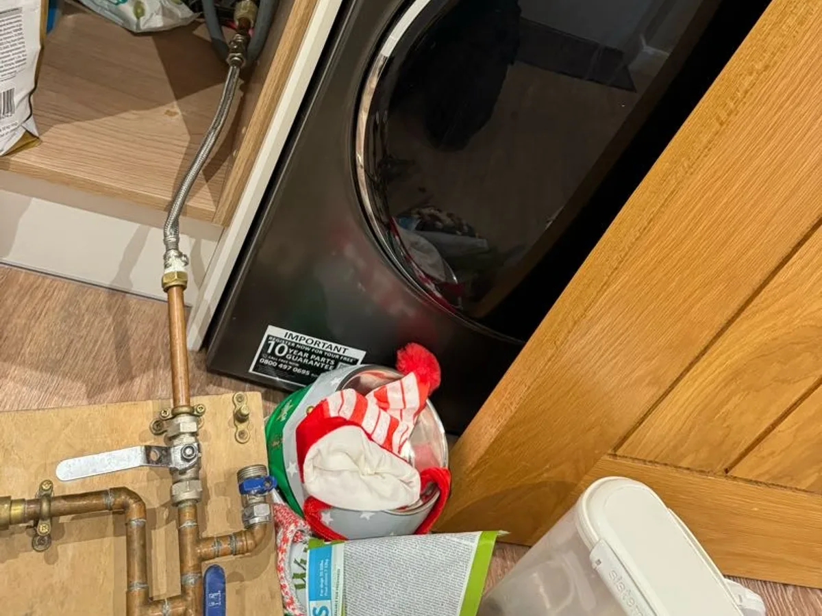 copper hot and cold pipework under utility sink connected for pressure testing during leak detection
