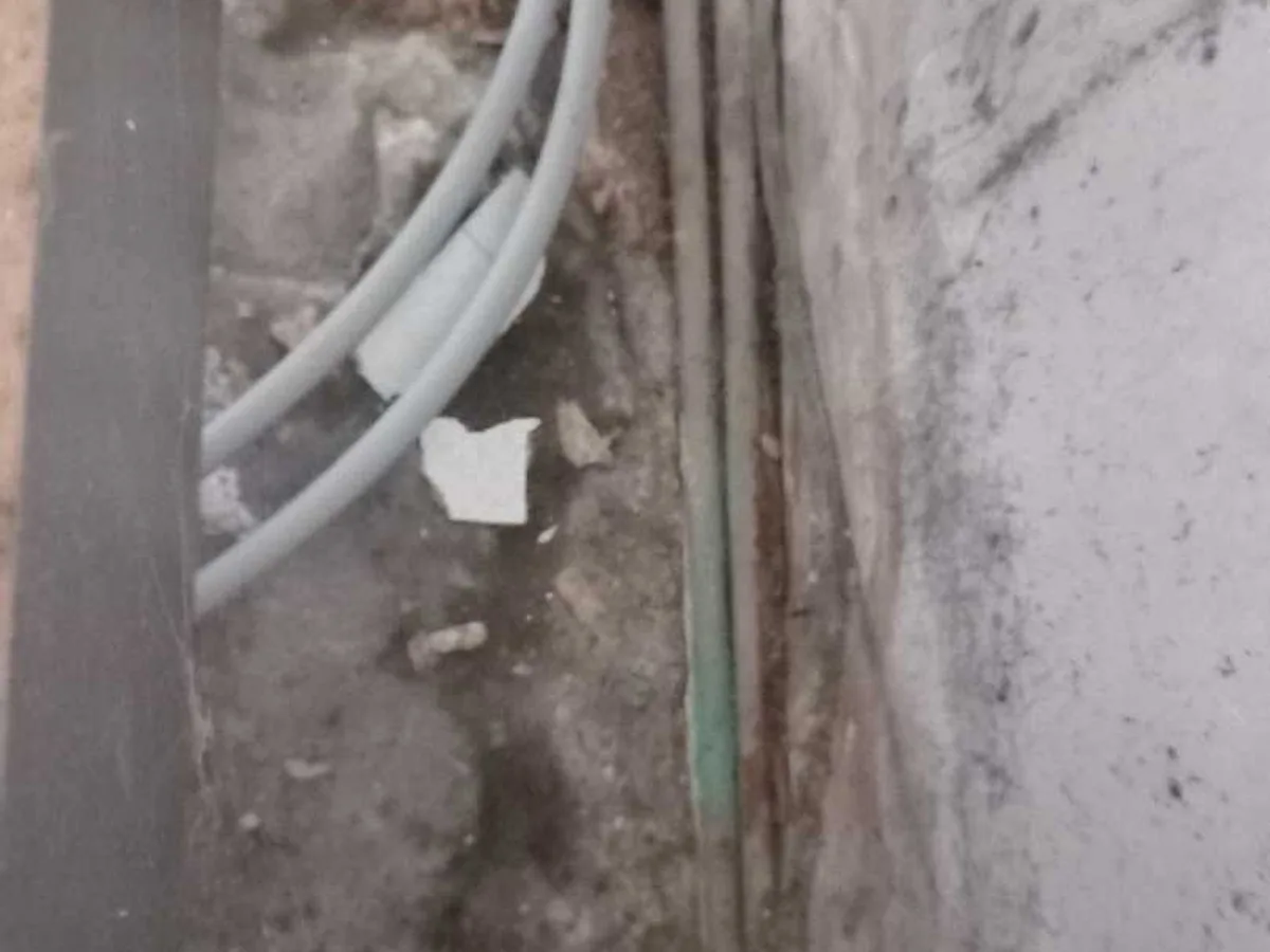 fault exposed at corroded hot-water and cold-water pipes beneath excavated concrete floor slab