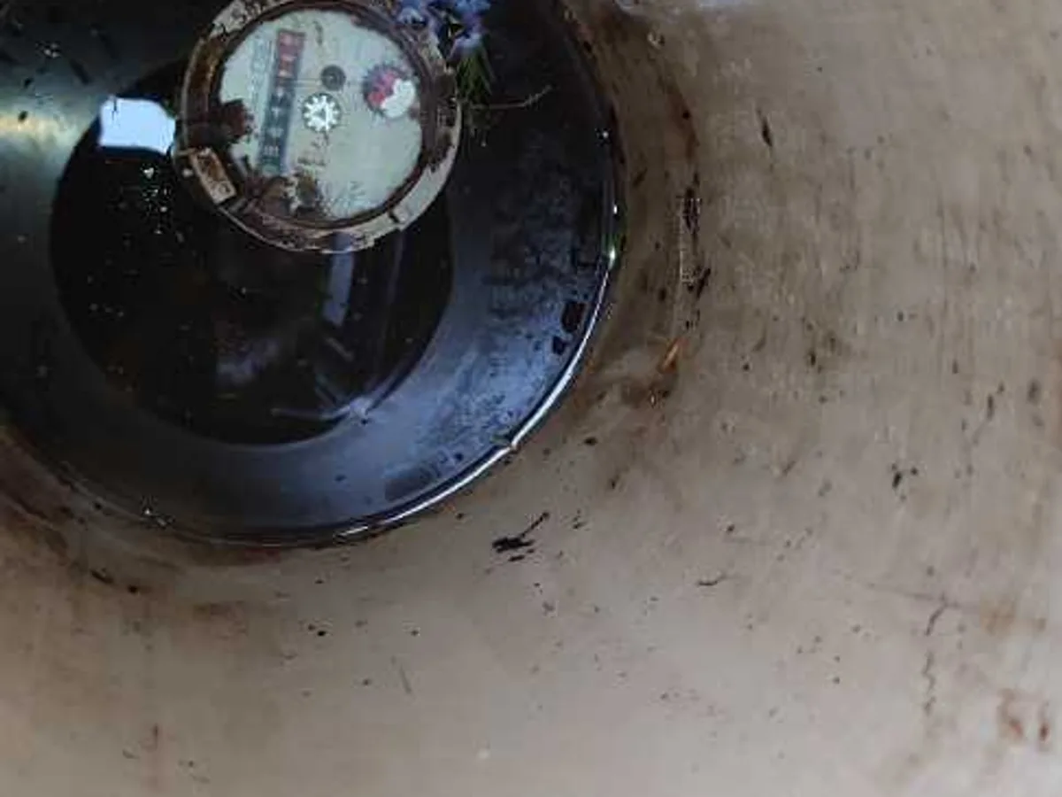 water meter dial viewed from above in stopcock chamber during leak detection