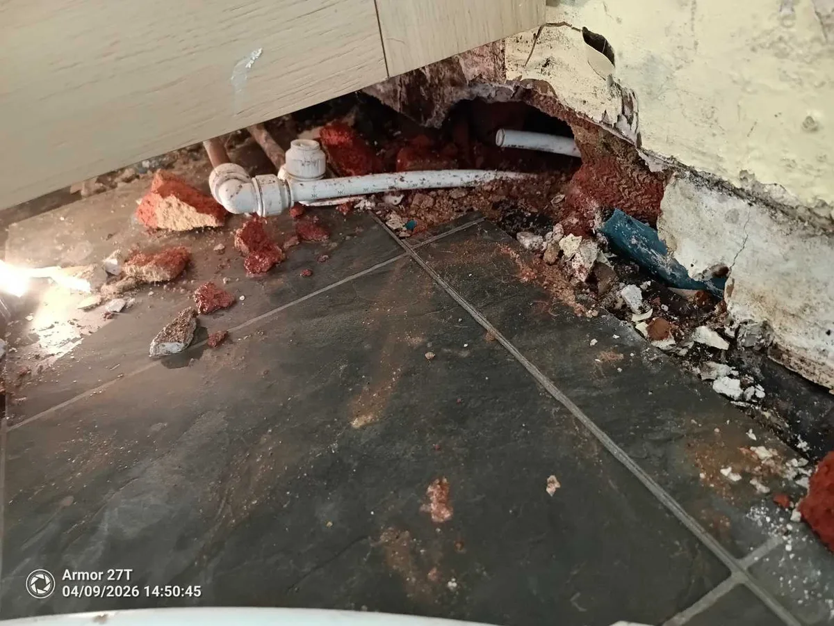 leak located at hot water pipe exposed after bricks removed from kitchen wall