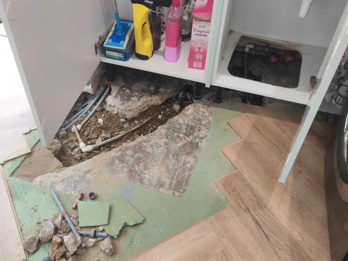 excavated kitchen floor with new push-fit pipework visible after works completed
