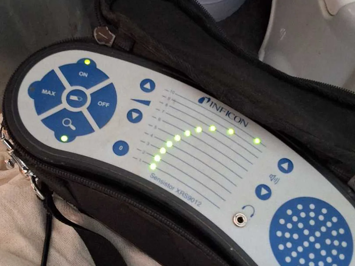 tracer gas detector showing active reading on LED bar display during leak detection survey